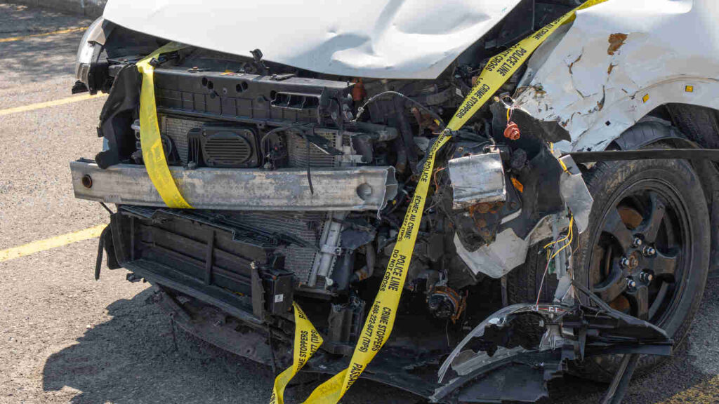 Close-up of a damaged car with police crime scene tape, highlighting the severity of collisions in Charlotte amidst a rise in serious and fatal accidents despite a drop in overall crashes.