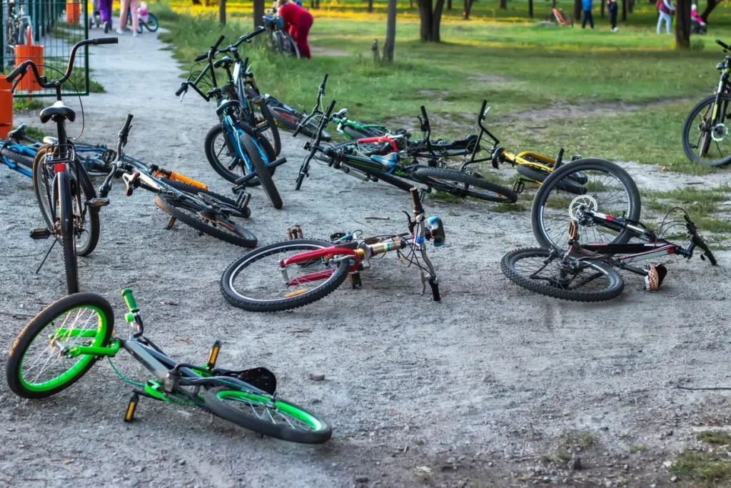 E-bikes scattered on the ground after a collision, raising questions about driver impairment and liability.